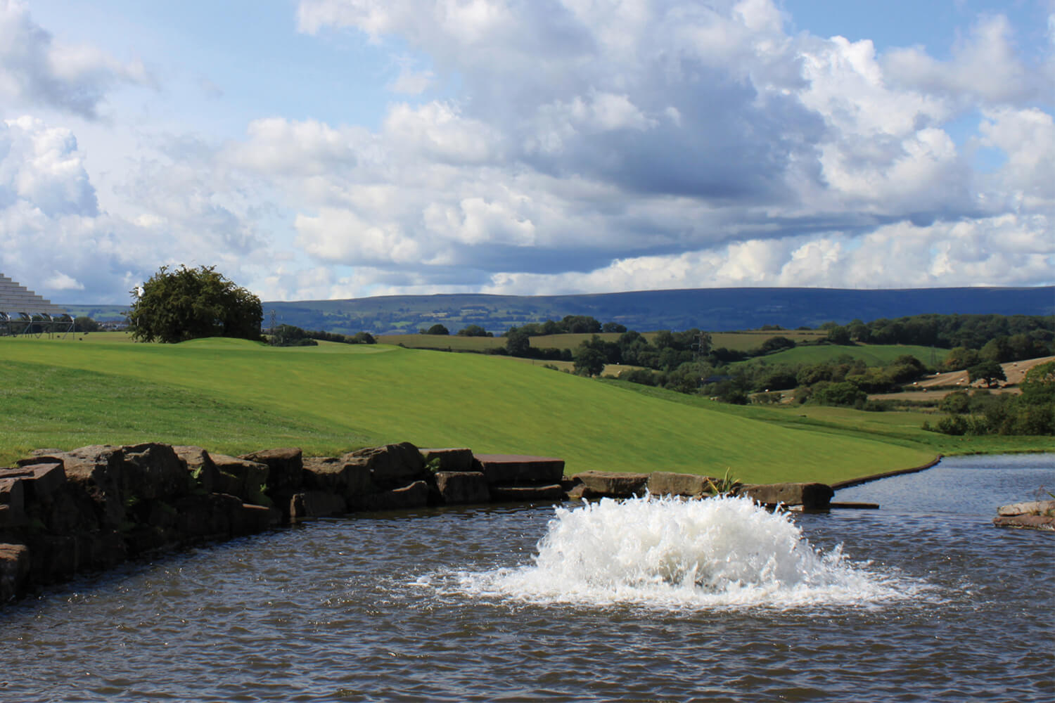 One of Otterbine's Industrial Pond Aerators with open fields in the distance