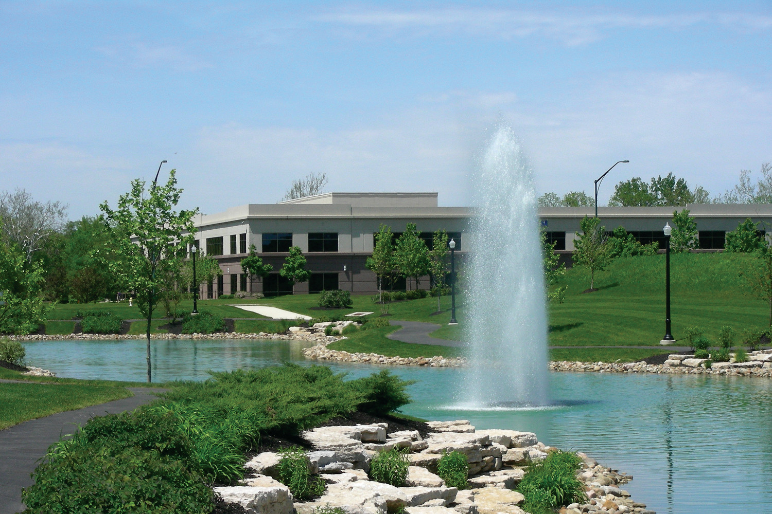 One of Otterbine's Polaris Aerating Fountains near a walking park